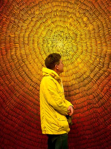 Scott Bicking in front of a sunburst artwork