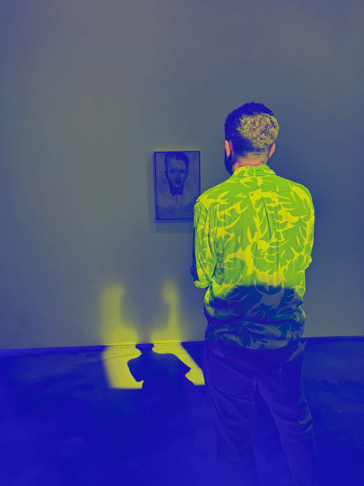 Scott Bicking viewing a framed portrait in a gallery
